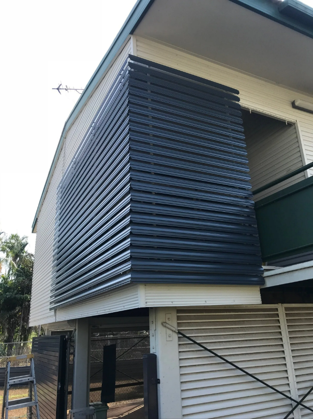 Exterior of a Modern House With Dark Horizontal Slatted Window Screens — NT Blinds in Yarrawonga, NT