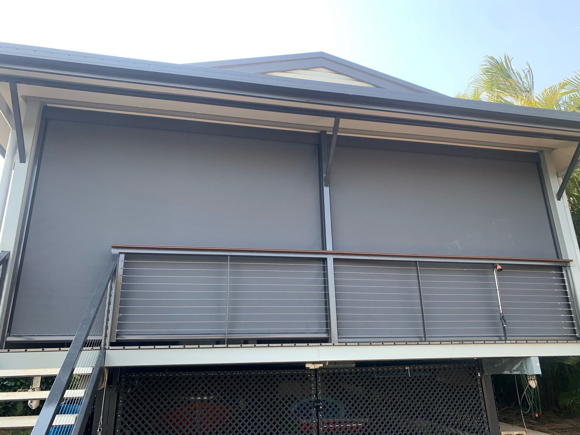 Gray outdoor blinds installed on a porch, protecting from sun — NT Blinds in Coolalinga, NT