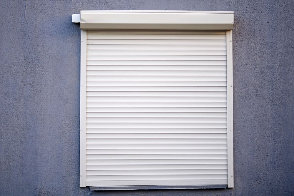 Closed White Window Shutter on a Gray Wall — NT Blinds in Yarrawonga, NT
