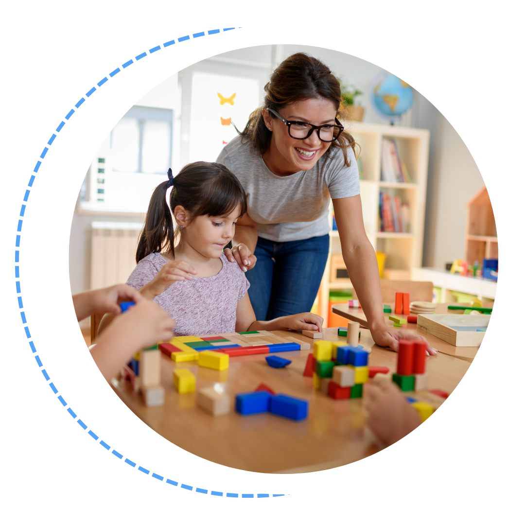 A woman is teaching a group of children how to play with wooden blocks.