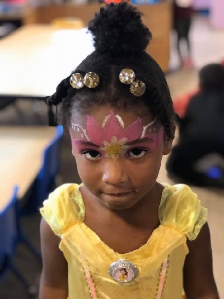 A little girl with a flower painted on her face