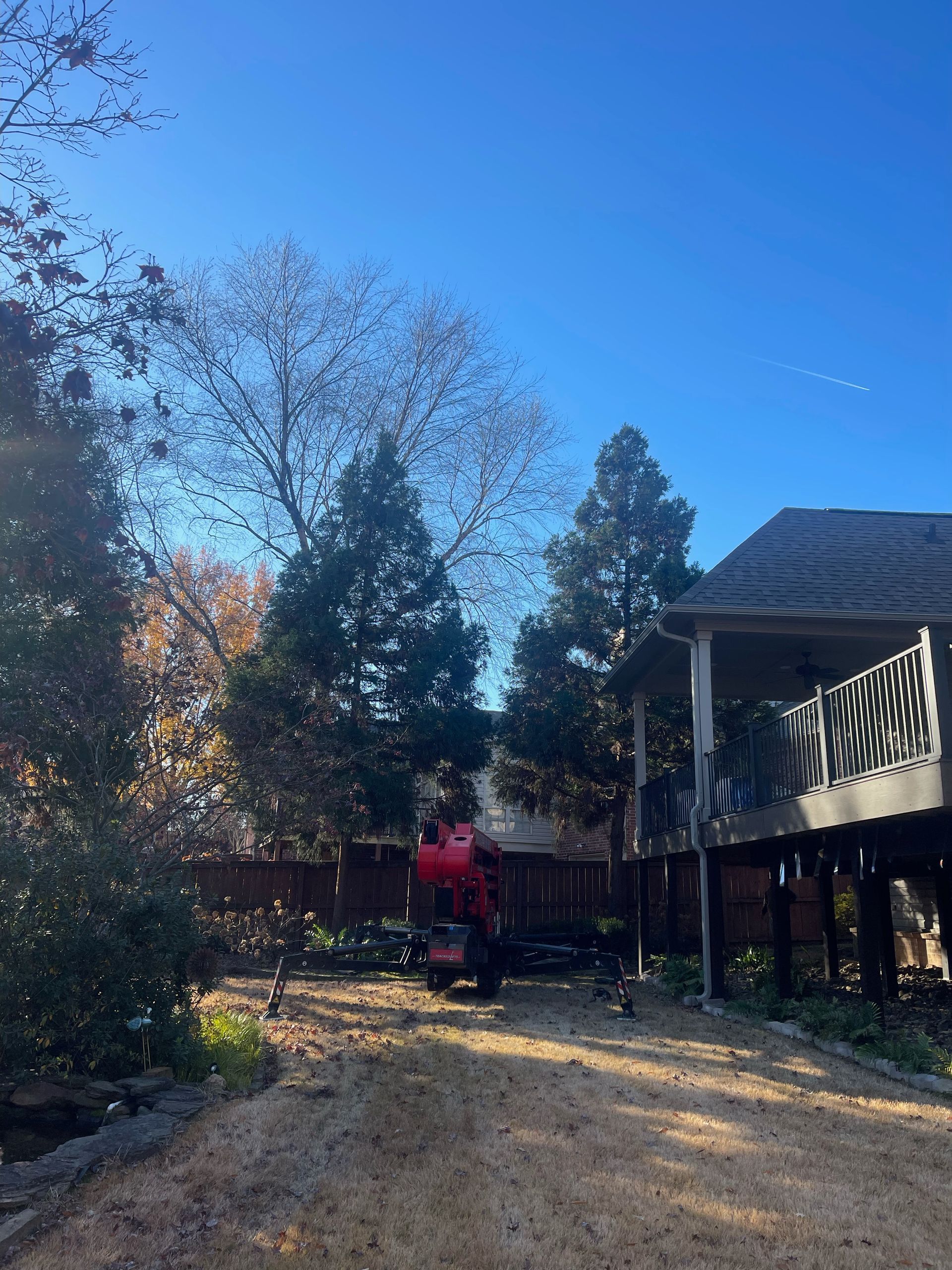 a red truck is parked in front of a house .