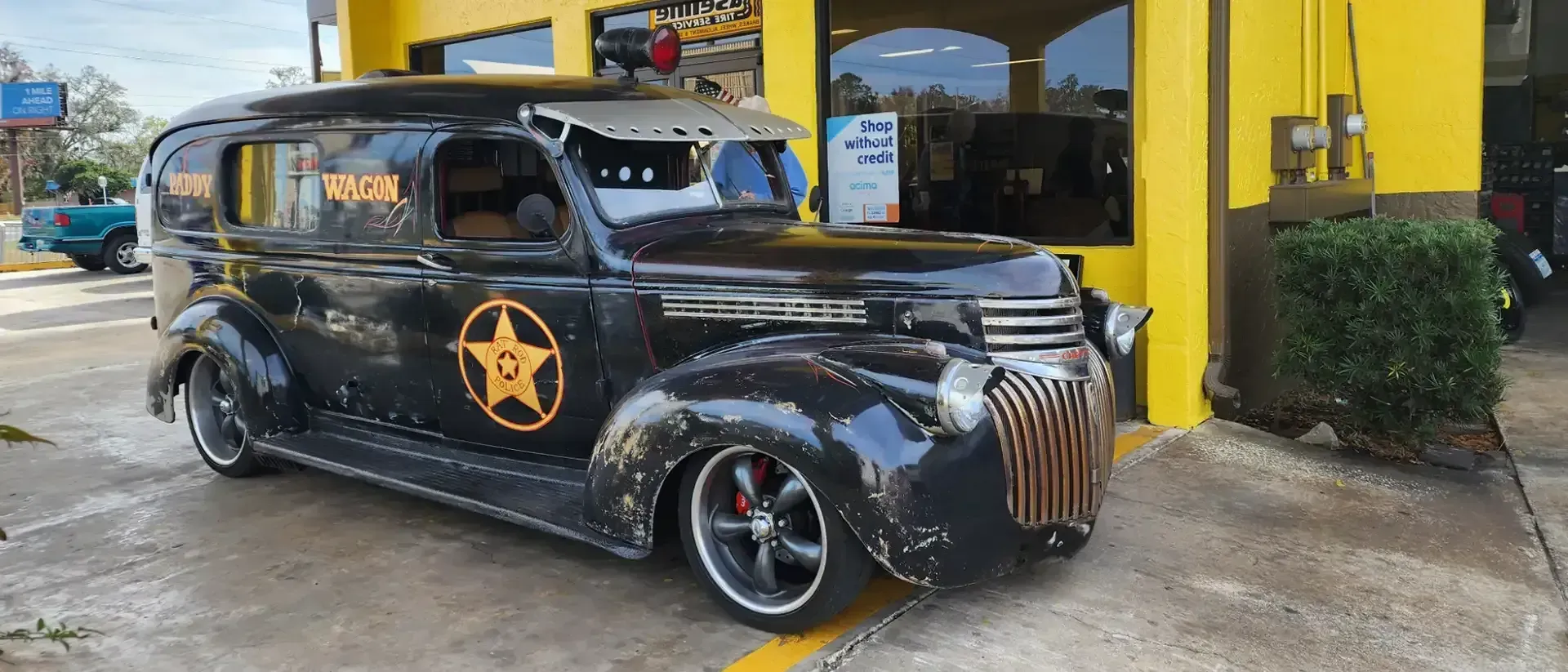 Black vintage car with orange star emblem and text 