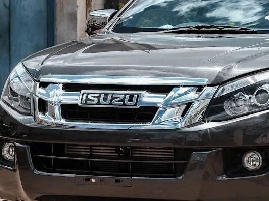 Close-up of a dark gray Isuzu D-Max truck's front grill and headlights.