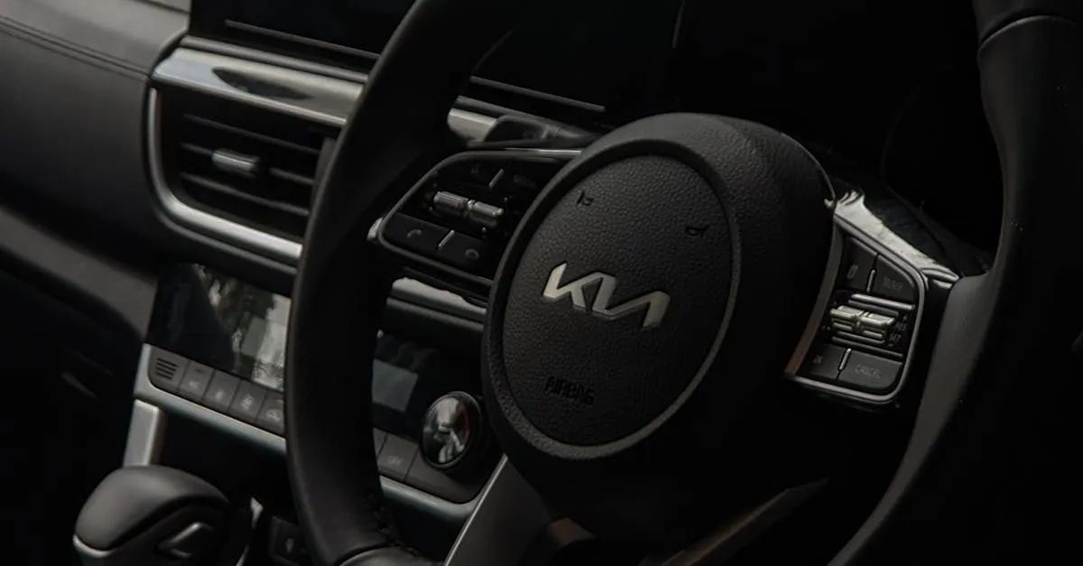 Steering wheel of a Kia car with the brand logo, and control buttons. Interior view.