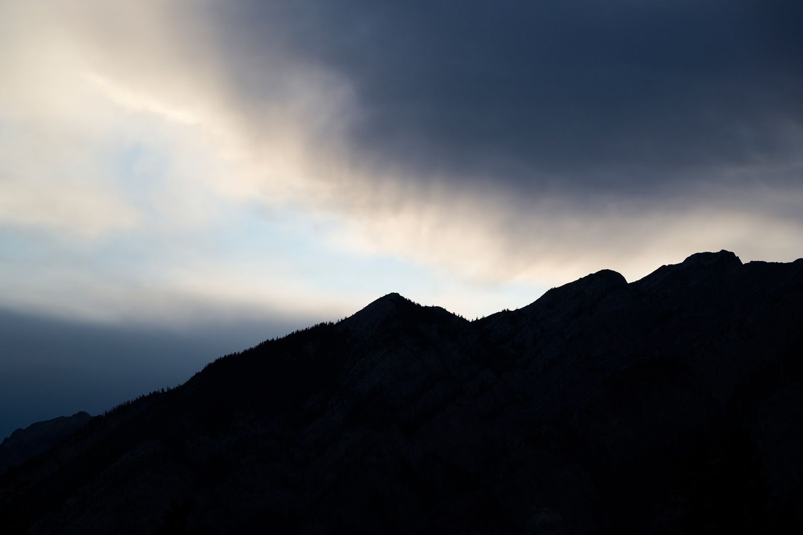 Silhouetted mountains at sunset in Banff, Alberta, Canada.