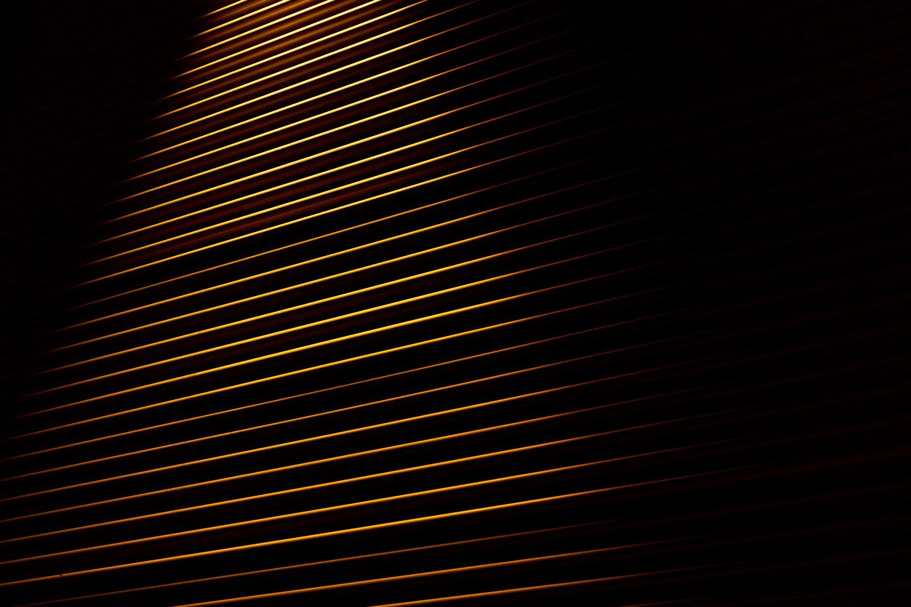 Pure abstraction of light washing the side of a metal clad building.