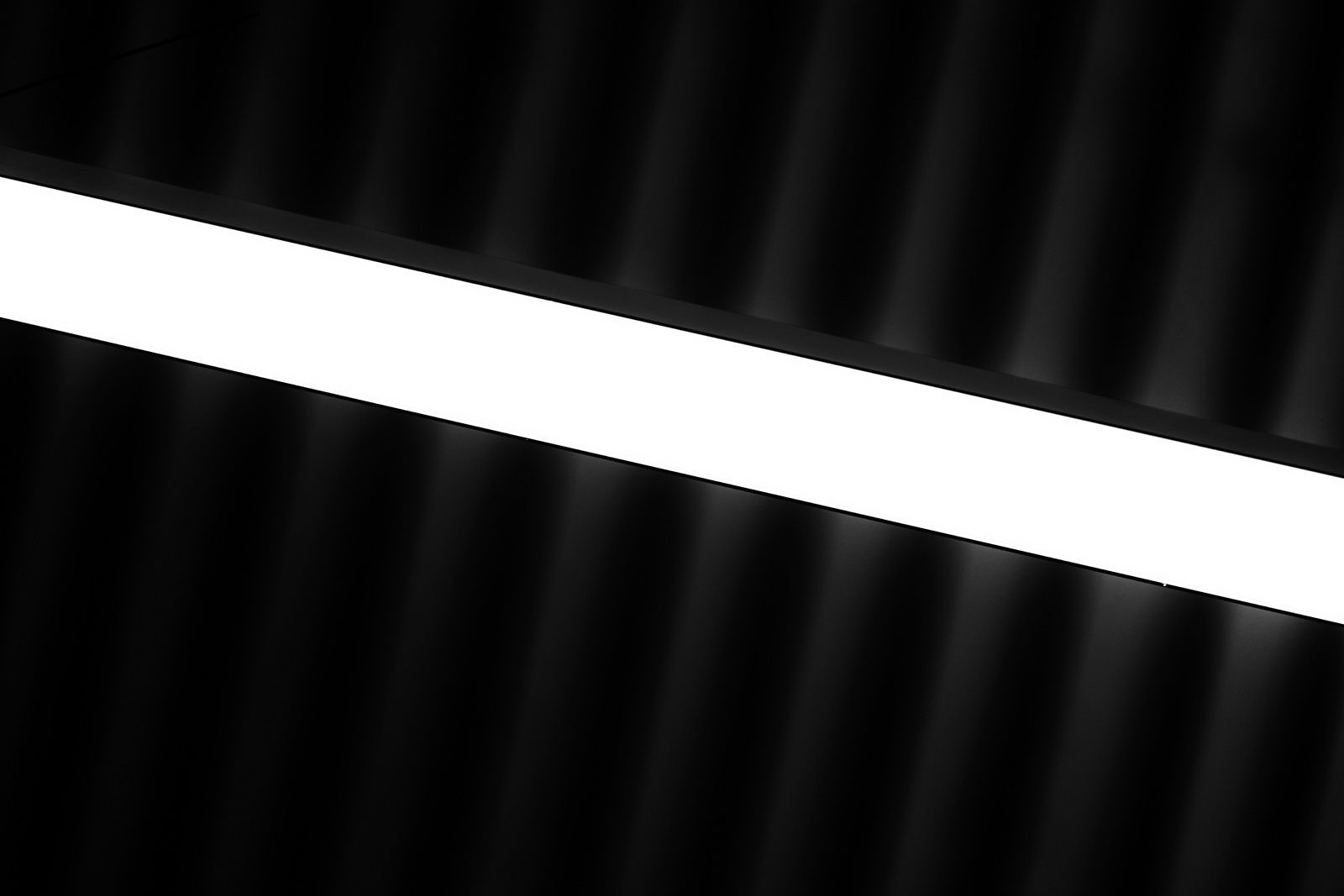 Abstraction of a corrugated metal ceiling and a LED tube light.
