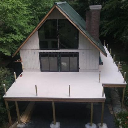 An aerial view of a house with a deck underneath it