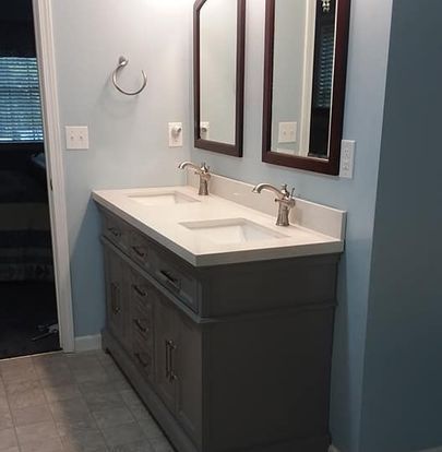 A bathroom with two sinks and two mirrors.