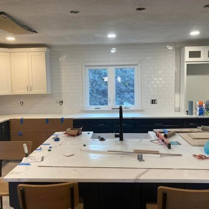 A kitchen under construction with a large island in the middle of the room.