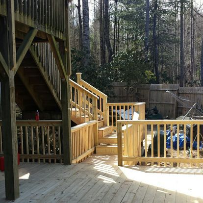 A wooden deck with stairs leading up to it