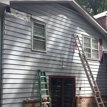 A house with a ladder on the side of it