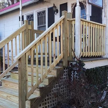 A wooden deck with stairs leading up to it