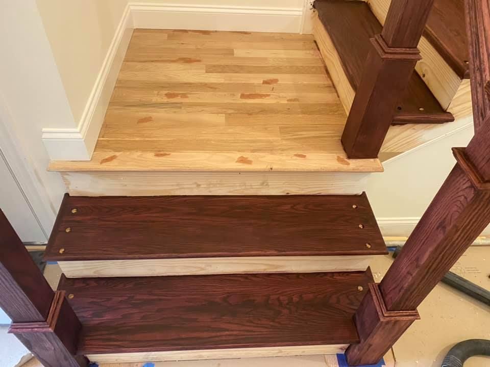 A wooden staircase with wooden steps and a wooden railing.