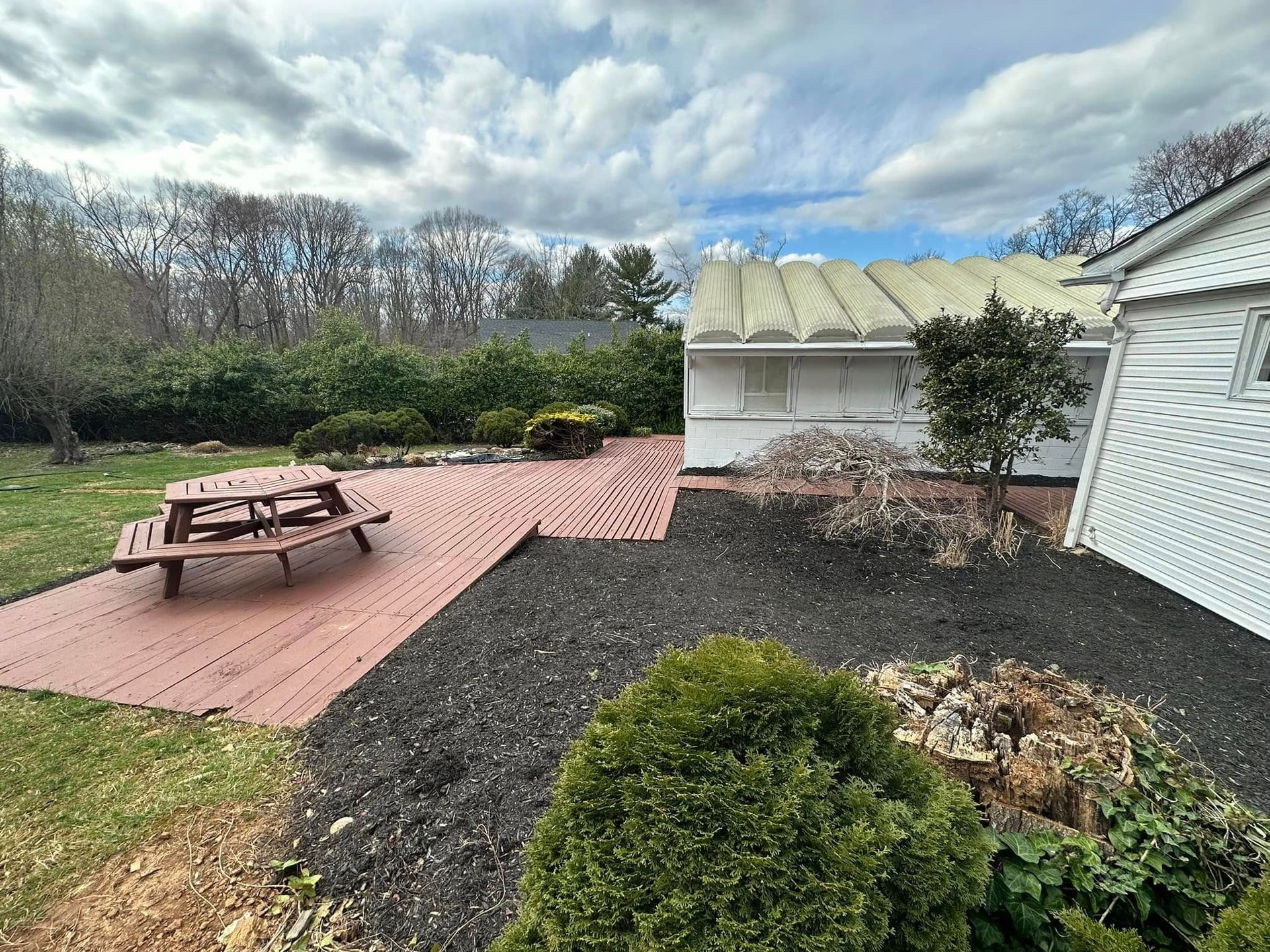 There is a picnic table in the backyard of a house.