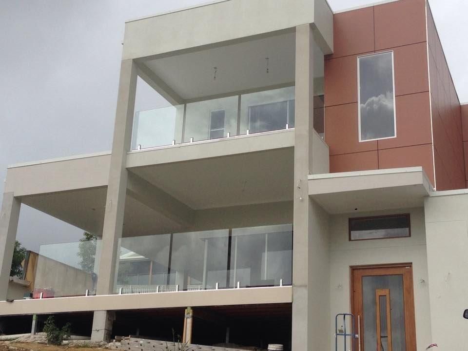 A Large Building With A Lot Of Windows And A Door — Frameless Shower Installations In Maroochydore, QLD
