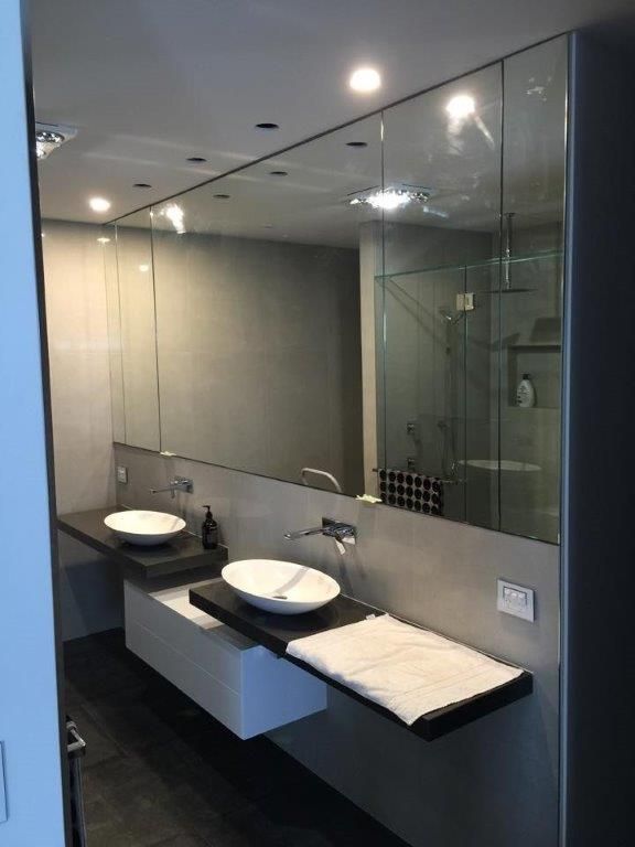 A Bathroom With Two Sinks And A Large Mirror — Frameless Shower Installations In Maroochydore, QLD