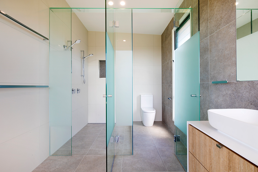 Modern Bathroom with Glass Shower and Toilet — Frameless Shower Installations In Maroochydore, QLD