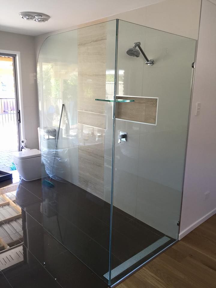 A Bathroom With A Walk In Shower And A Toilet — Frameless Shower Installations In Caloundra, QLD