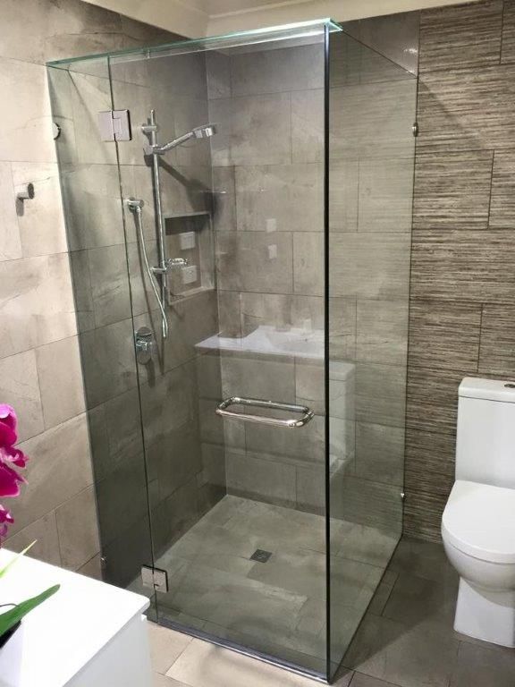 A Bathroom With A Walk In Shower And A Toilet — Frameless Shower Installations In Maroochydore, QLD