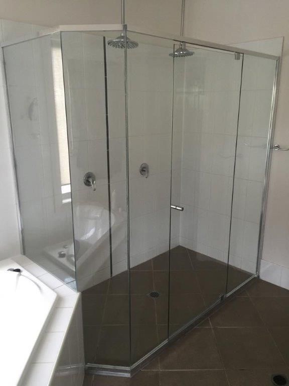 A Bathroom With A Walk In Shower And A Bathtub — Frameless Shower Installations In Maroochydore, QLD