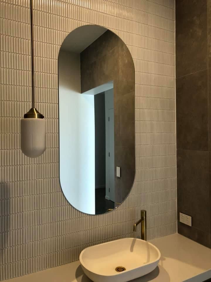A Bathroom With A Sink And A Mirror On The Wall — Frameless Shower Installations In Maroochydore, QLD