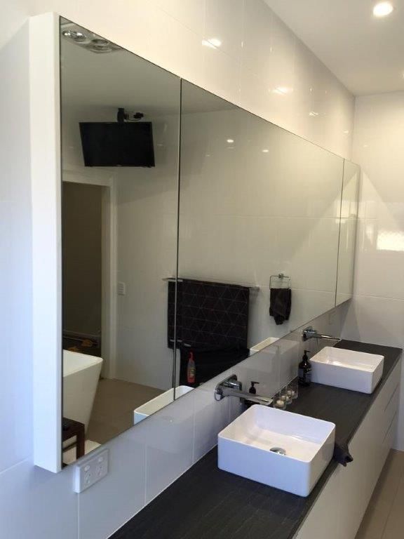 A Bathroom With Two Sinks And A Large Mirror — Frameless Shower Installations In Maroochydore, QLD