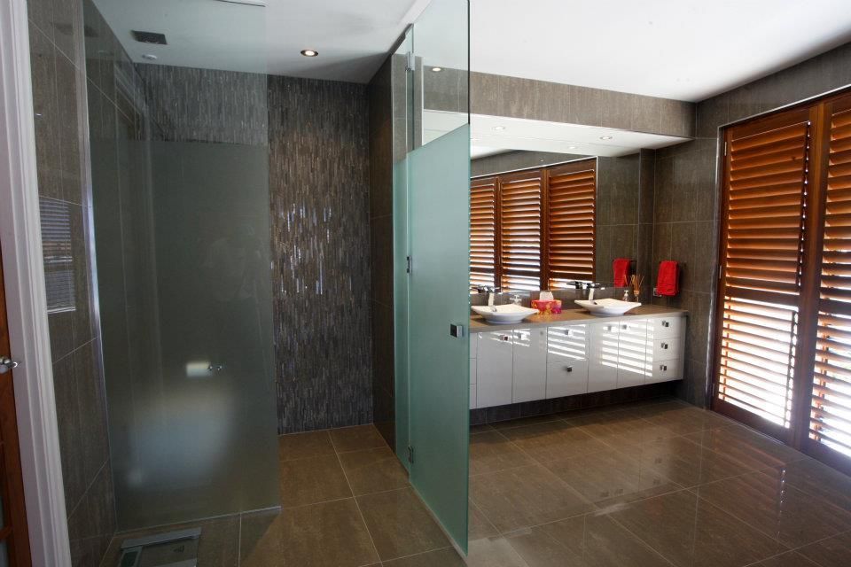A Bathroom With Two Sinks And A Walk In Shower — Frameless Shower Installations In Caloundra, QLD