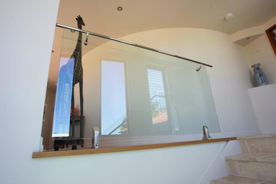 A Staircase With a Glass Railing and a Giraffe Statue — Frameless Shower Installations In Maroochydore, QLD 