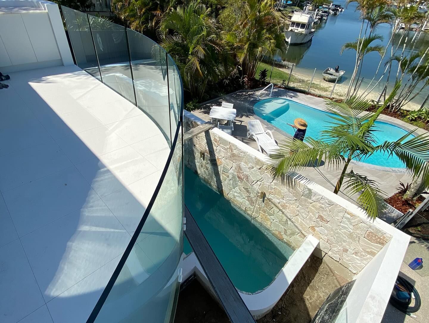 A Kitchen With Black Cabinets, a Sink, and a Stove Top Oven — Frameless Shower Installations In Noosa, QLD
