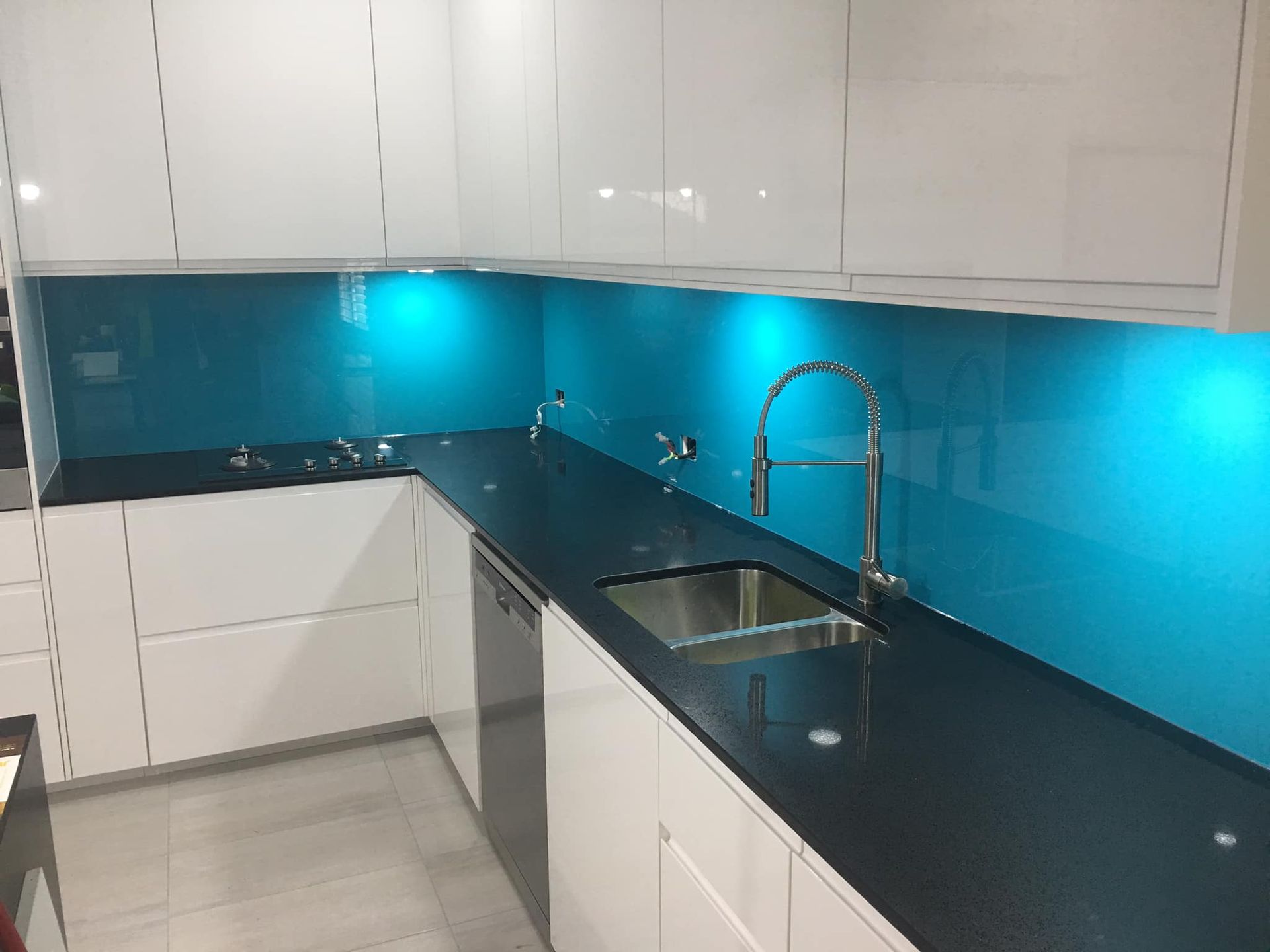 A Kitchen With Blue Counter Tops And White Cabinets — Frameless Shower Installations In Maroochydore, QLD