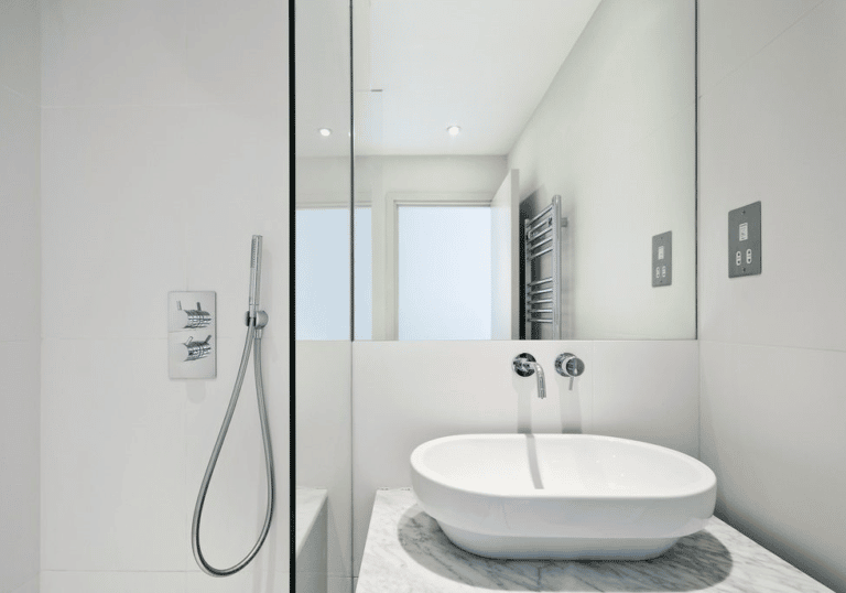 A Bathroom With A Sink , Shower And Mirror — Frameless Shower Installations In Maroochydore, QLD