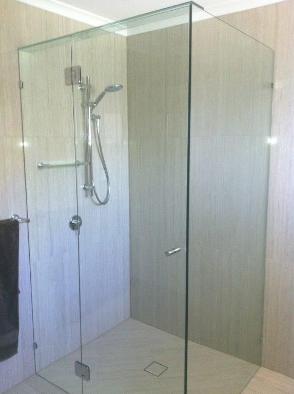 A Bathroom With A Walk In Shower With A Glass Door — Frameless Shower Installations In Maroochydore, QLD