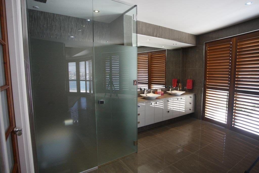 A Bathroom With Two Sinks And A Walk In Shower — Frameless Shower Installations In Maroochydore, QLD