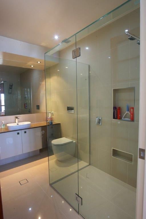 A Bathroom With A Walk In Shower And A Toilet — Frameless Shower Installations In Maroochydore, QLD