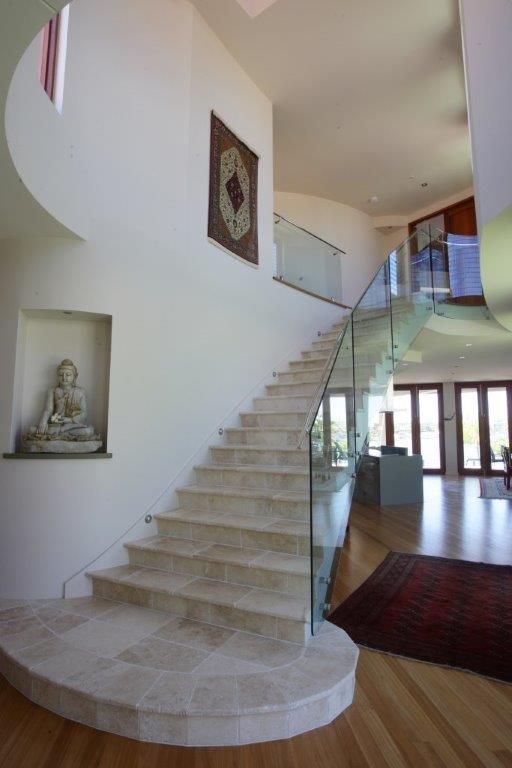 A Staircase With A Glass Railing In A House — Frameless Shower Installations In Maroochydore, QLD