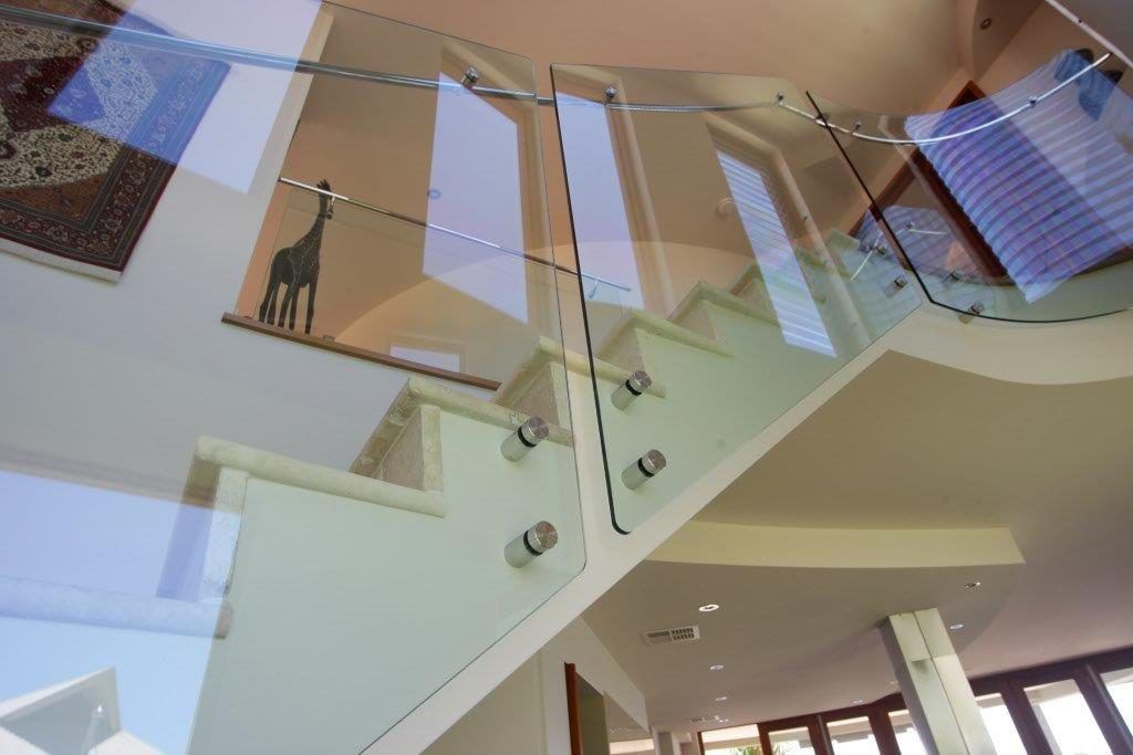 A Staircase With A Glass Railing In A House — Frameless Shower Installations In Maroochydore, QLD