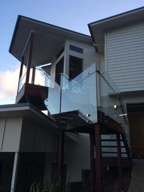 A House With A Glass Railing On The Side Of It — Frameless Shower Installations In Maroochydore, QLD