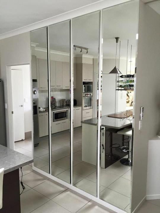 A Kitchen With A Lot Of Mirrors On The Wall — Frameless Shower Installations In Maroochydore, QLD