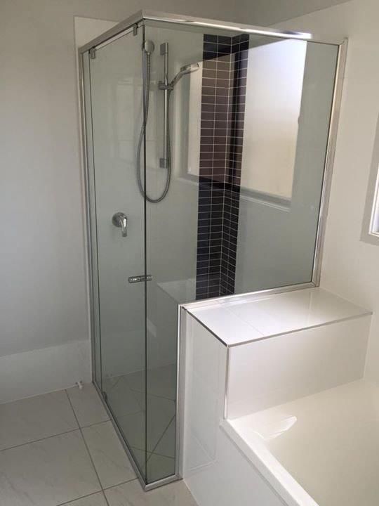 A Bathroom With A Shower Stall And A Bathtub — Frameless Shower Installations In Maroochydore, QLD
