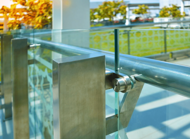 A Stainless Steel Railing With Glass — Frameless Shower Installations In Maroochydore, QLD