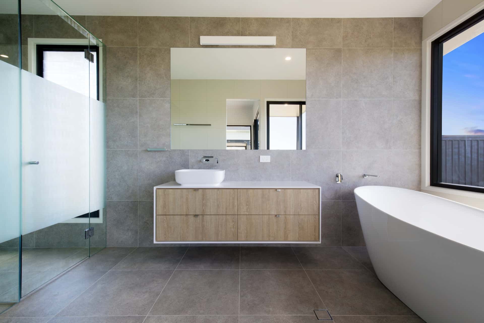 Modern Bathroom with Gray Tiled Walls and Floors — Frameless Shower Installations In Maroochydore, QLD