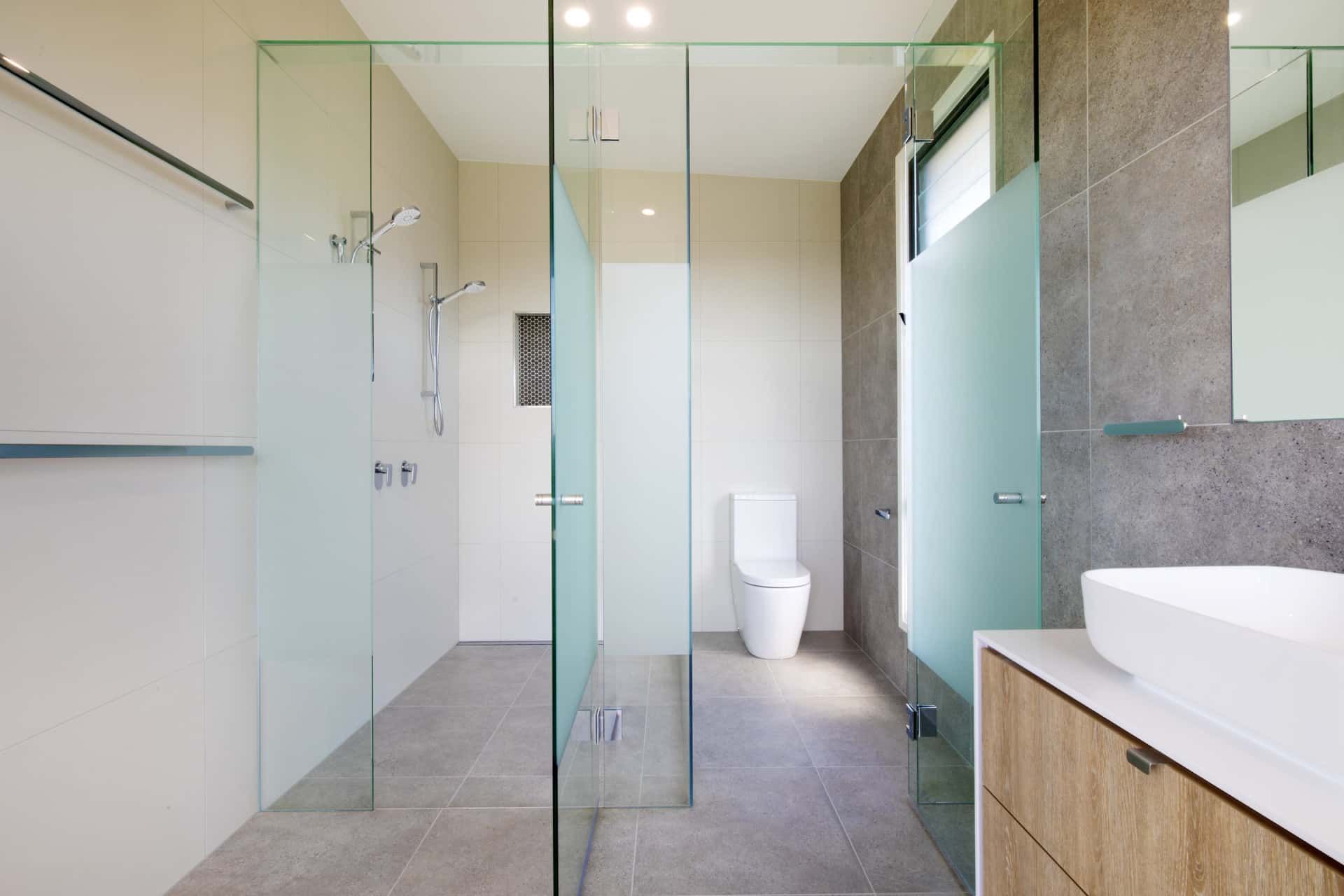 A Modern Bathroom with Glass Shower and Toilet Enclosures — Frameless Shower Installations In Maroochydore, QLD