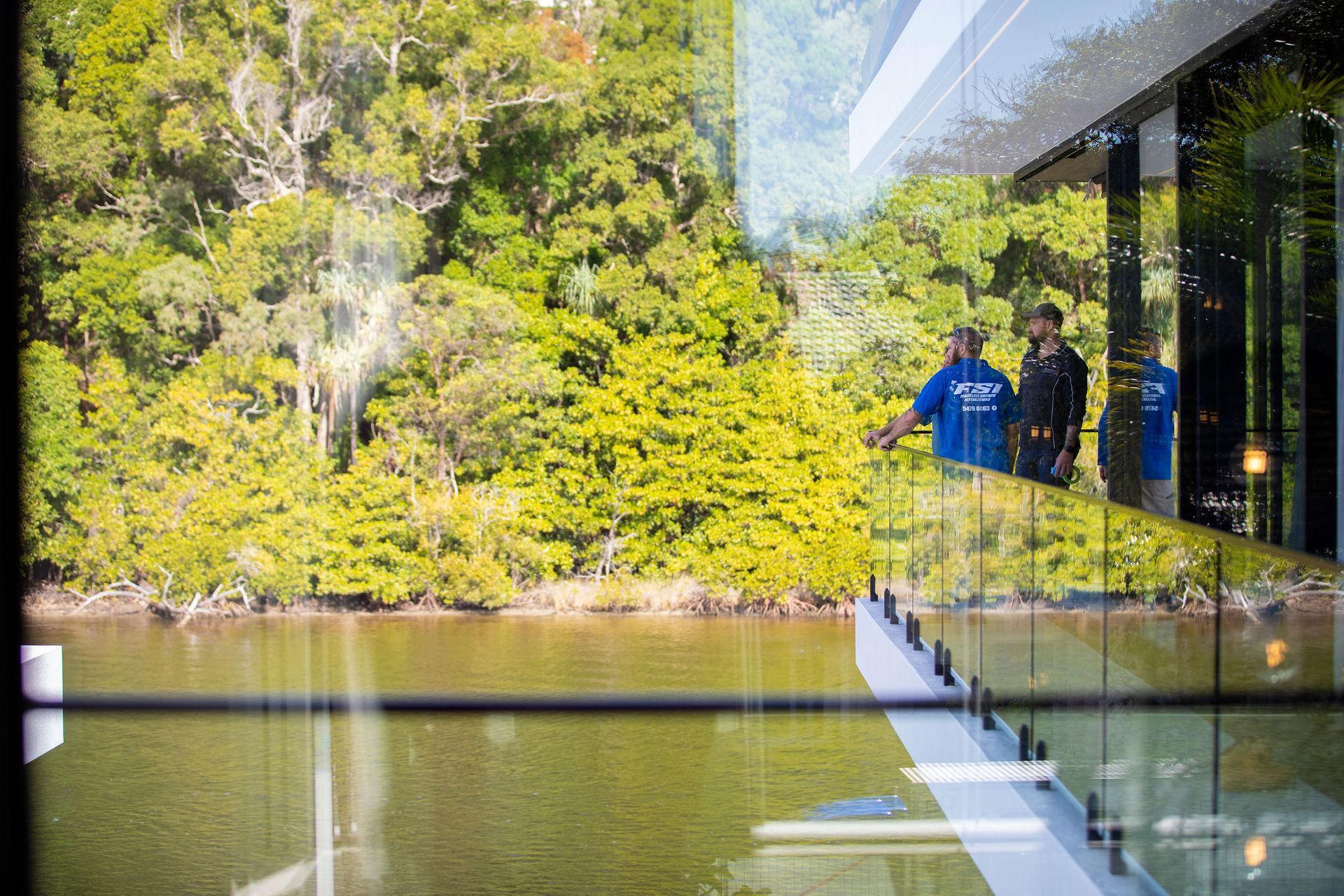 A Staircase With a Glass Railing and a Giraffe Statue — Frameless Shower Installations In Maroochydore, QLD 