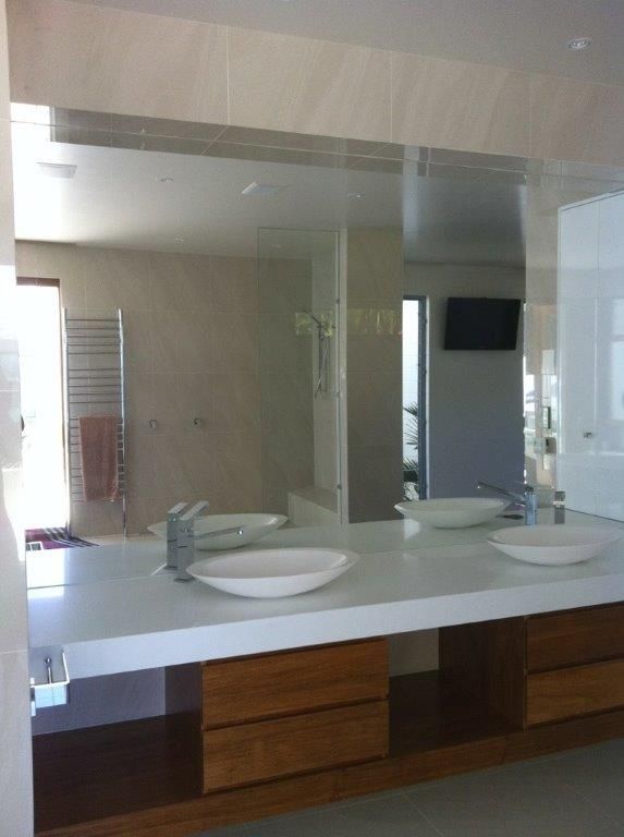 A Bathroom With Two Sinks And A Large Mirror — Frameless Shower Installations In Maroochydore, QLD