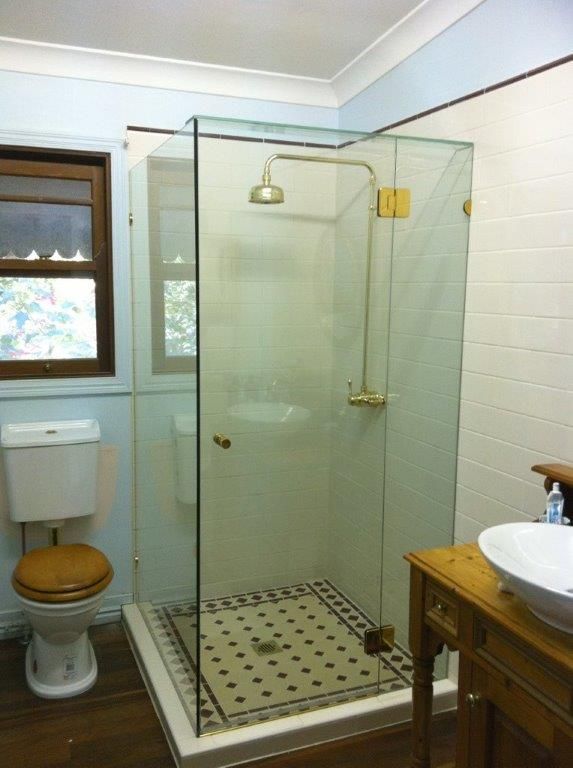 A Bathroom With A Toilet A Sink And A Walk In Shower — Frameless Shower Installations In Maroochydore, QLD