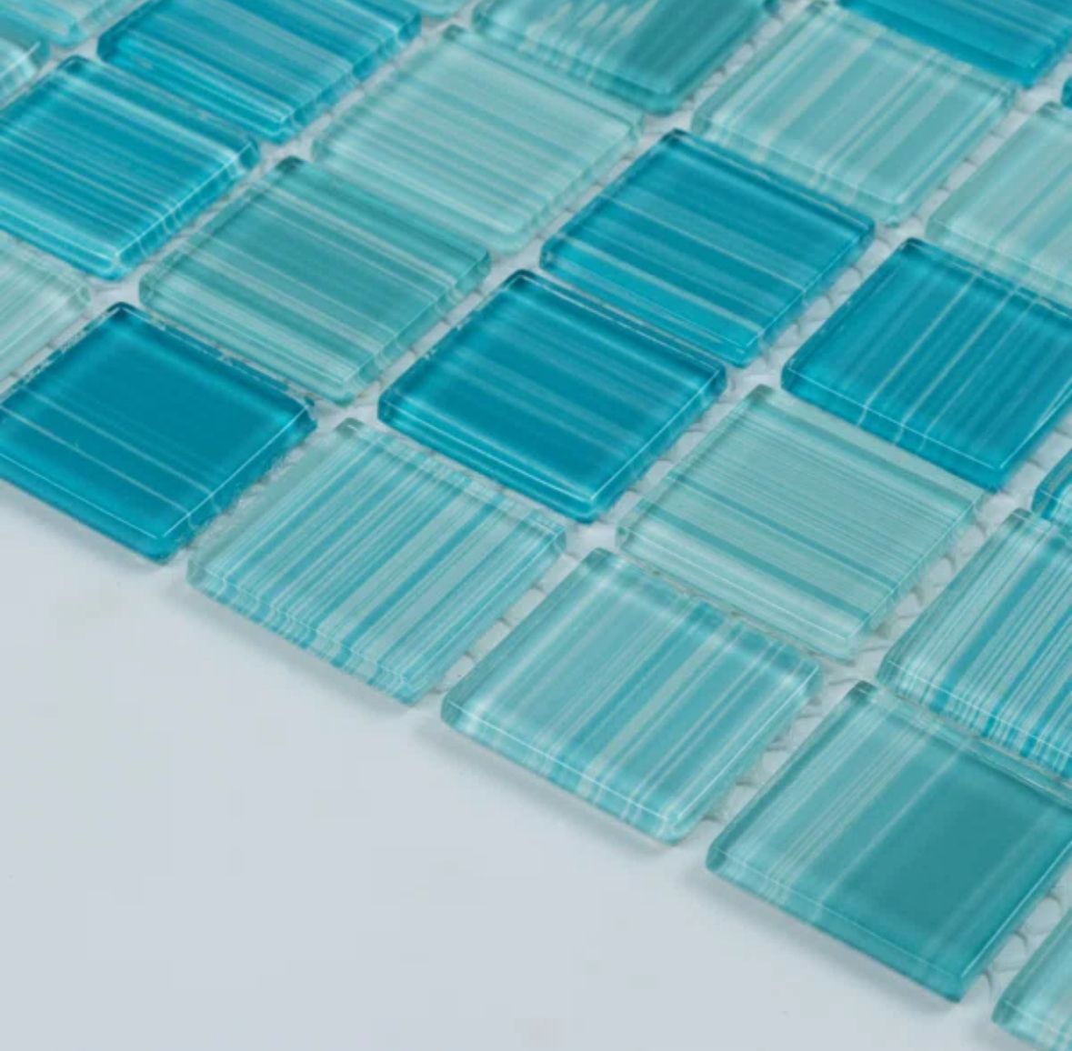 Close-up of square, turquoise glass tiles arranged in a grid pattern.