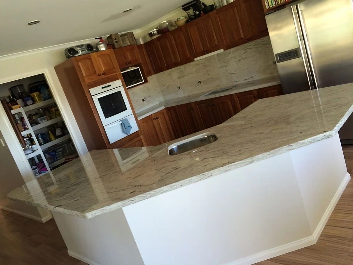 A Kitchen with Stainless Steel Appliances and Granite Counter Tops — Sheridan Stone Aust in Toormina, NSW