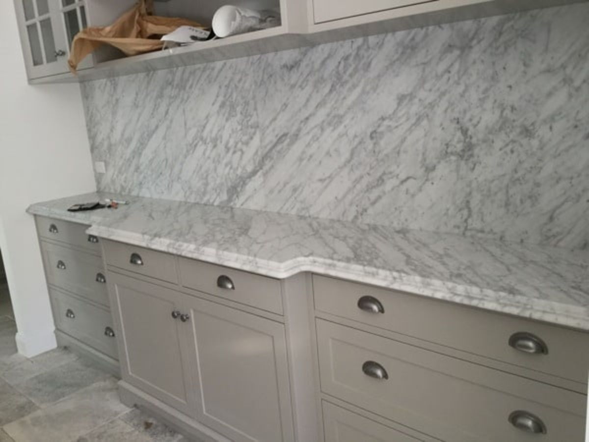 A Kitchen with White Cabinets and Marble Counter Tops — Sheridan Stone Aust in Grafton, NSW